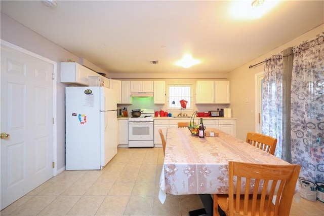 kitchen featuring white appliances, white cabinetry, and sink