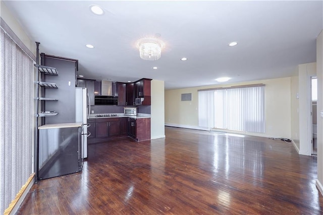 kitchen with stainless steel appliances, a wealth of natural light, and dark wood-type flooring