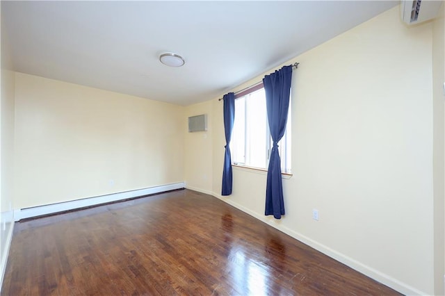 spare room featuring hardwood / wood-style flooring and a baseboard radiator