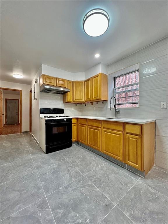 kitchen with tasteful backsplash, white range with gas cooktop, and sink