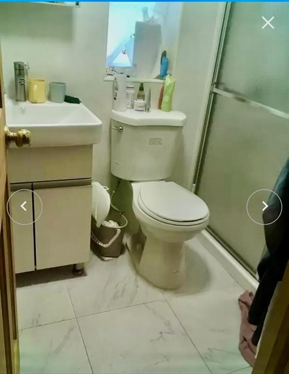 bathroom with vanity, toilet, and walk in shower