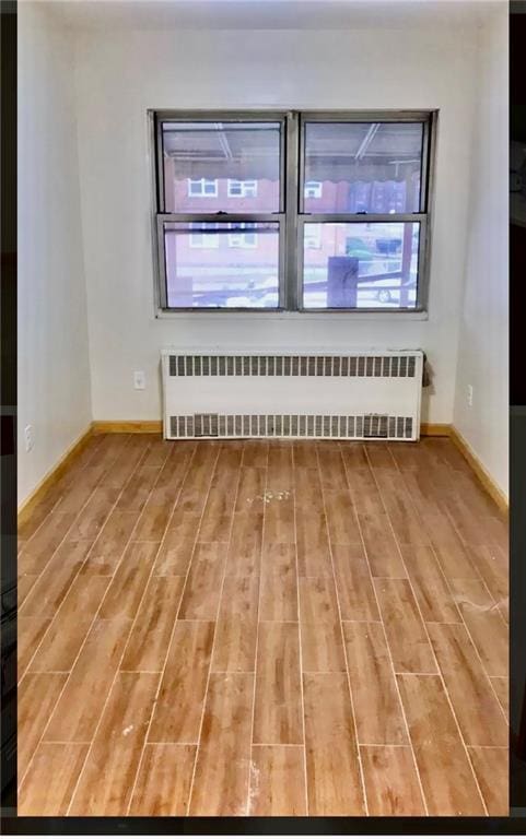 empty room featuring radiator heating unit