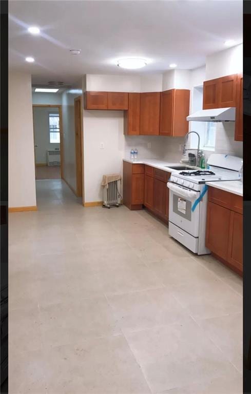 kitchen featuring white range with gas cooktop and sink