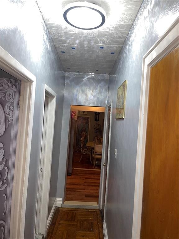 hallway with dark parquet flooring