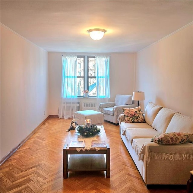 living room featuring crown molding, light parquet flooring, and radiator