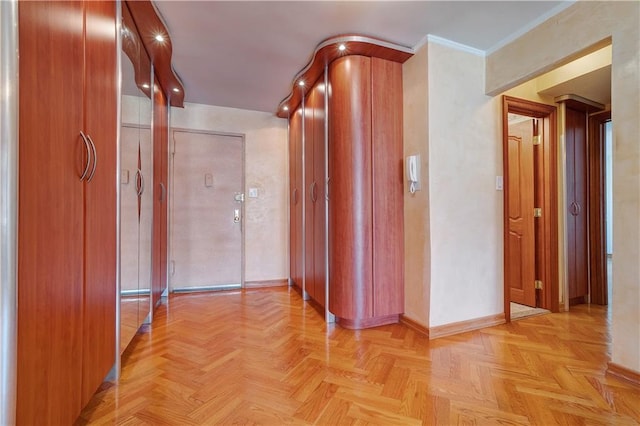 hallway with ornamental molding and light parquet floors