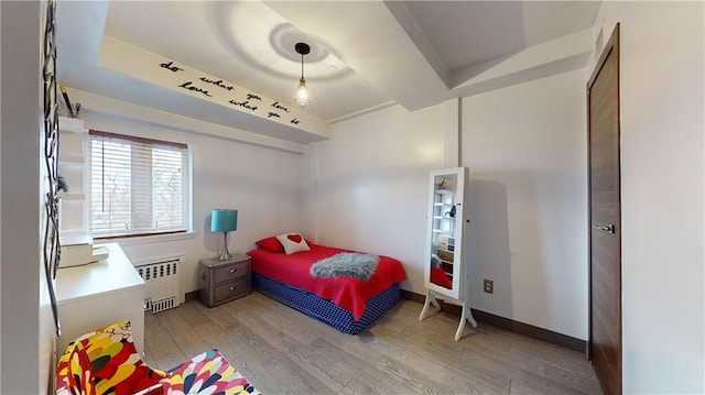 bedroom featuring light hardwood / wood-style flooring and radiator heating unit