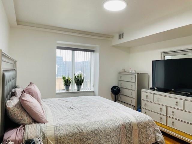 bedroom with hardwood / wood-style flooring