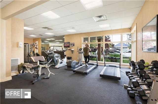 exercise room with visible vents and a paneled ceiling