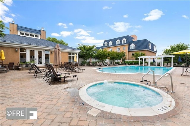 view of pool featuring a community hot tub, a pergola, a patio, and french doors