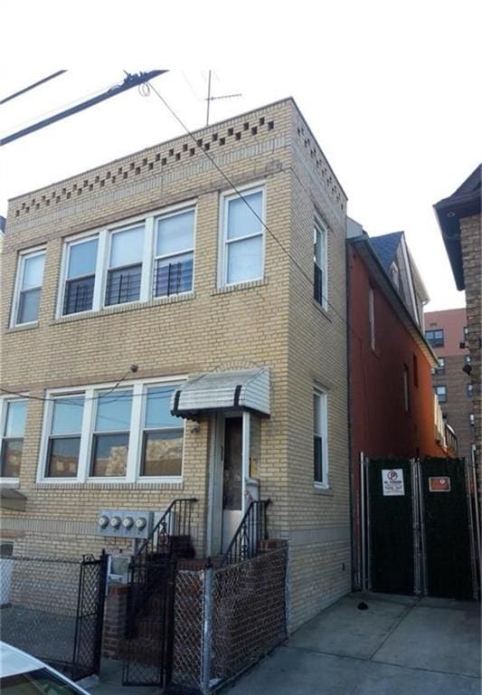 2530 Coney Island Ave, Brooklyn, NY 11223 - view of front facade with brick siding, fence private yard, and a gate
