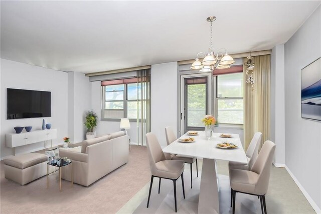 carpeted dining room featuring a chandelier