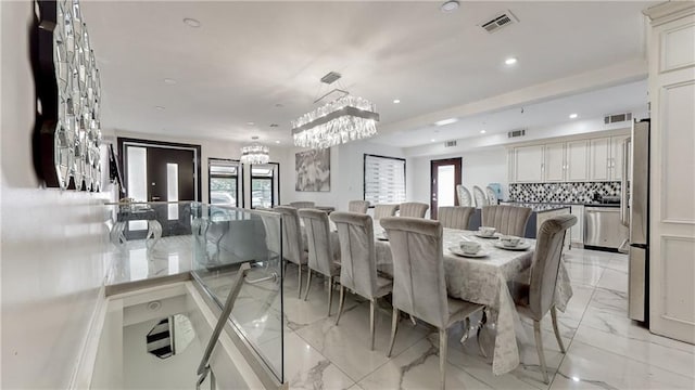 dining area with french doors, a notable chandelier, and plenty of natural light