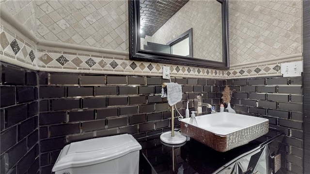 bathroom featuring tile walls, vanity, and toilet