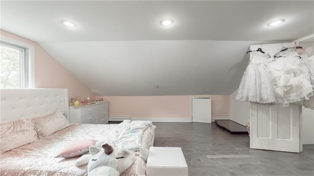 bedroom with hardwood / wood-style flooring and vaulted ceiling