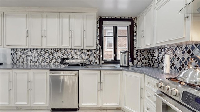 kitchen with decorative backsplash, sink, stainless steel appliances, and white cabinets