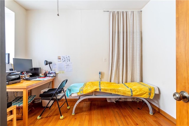 office space featuring baseboards and wood finished floors