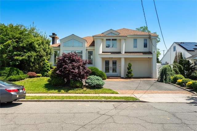 2729 Shore Dr, Merrick, NY 11566 - view of front of property with an attached garage, french doors, and aphalt driveway