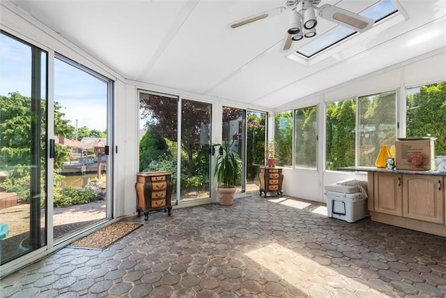 unfurnished sunroom featuring ceiling fan and lofted ceiling