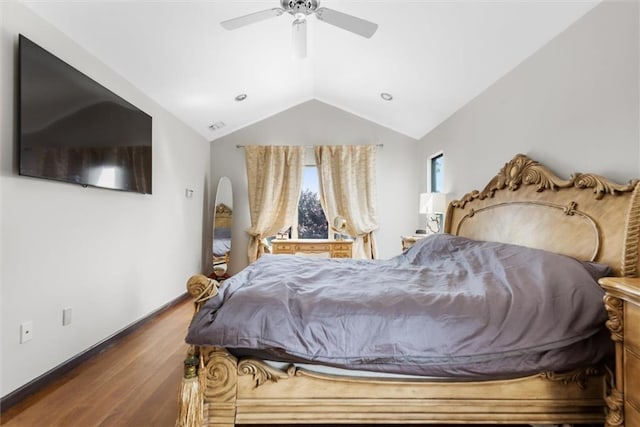 bedroom with lofted ceiling, hardwood / wood-style flooring, and ceiling fan