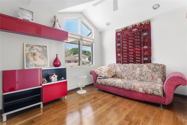 sitting room with hardwood / wood-style flooring, vaulted ceiling, and ceiling fan