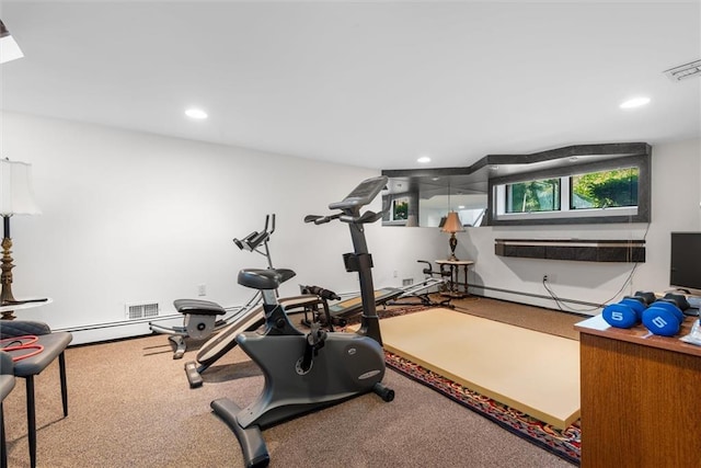 workout room featuring baseboard heating and carpet