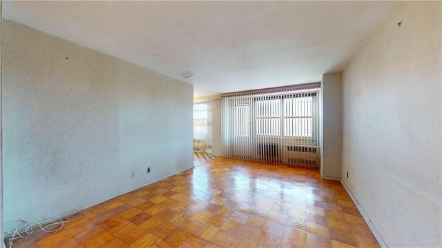 unfurnished room with light parquet floors