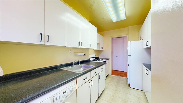 kitchen featuring washer / clothes dryer, sink, white cabinets, and white appliances