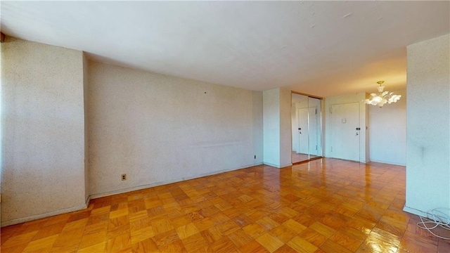 unfurnished room with an inviting chandelier