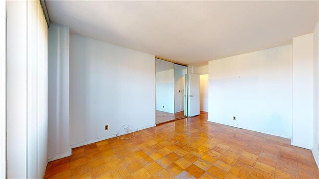 spare room with light parquet flooring