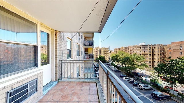 balcony with visible vents and a city view