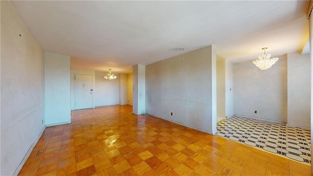 spare room featuring a notable chandelier