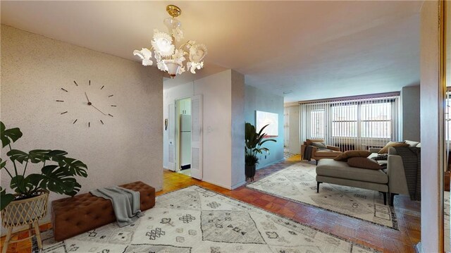 living room with a notable chandelier and light parquet flooring