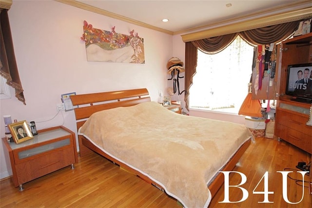 bedroom with recessed lighting, wood finished floors, baseboards, and ornamental molding