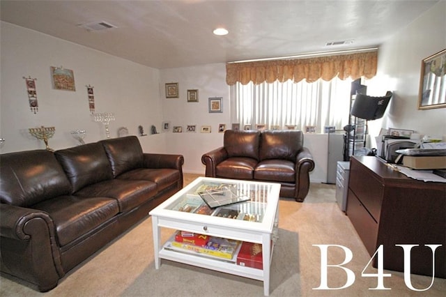 living area with light colored carpet and visible vents