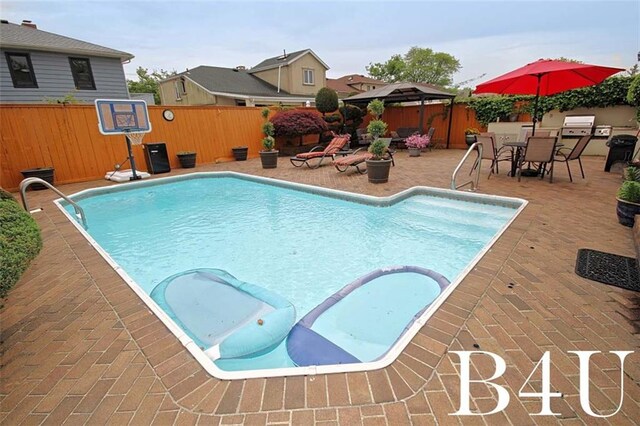 view of swimming pool featuring a gazebo and a patio