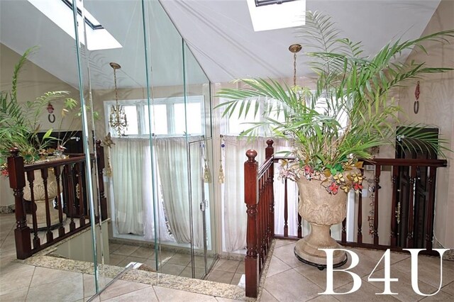 interior space featuring tile patterned flooring and a skylight