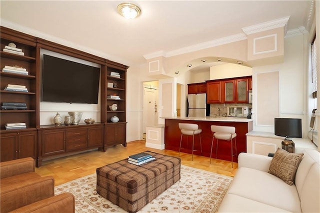 living area with visible vents and crown molding