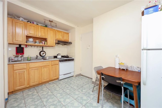 kitchen featuring backsplash, white appliances, and sink