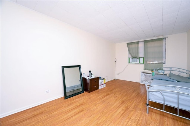 bedroom with light wood-style floors and baseboards