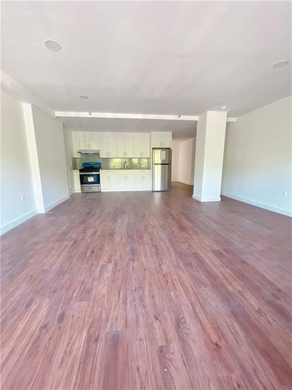 unfurnished living room featuring dark hardwood / wood-style floors