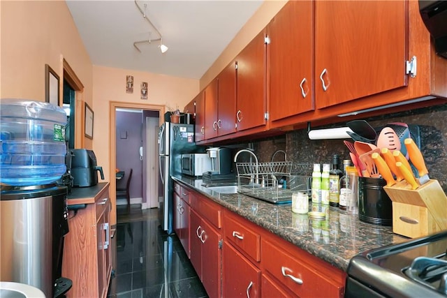 kitchen featuring tasteful backsplash, sink, and track lighting