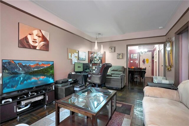 living room with a notable chandelier and dark parquet floors