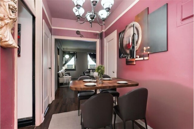 dining room featuring dark hardwood / wood-style floors and a notable chandelier