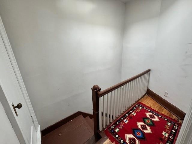 stairs with hardwood / wood-style floors