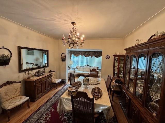 dining room with a notable chandelier and wood-type flooring