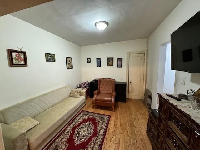 living room featuring light wood-type flooring and radiator heating unit