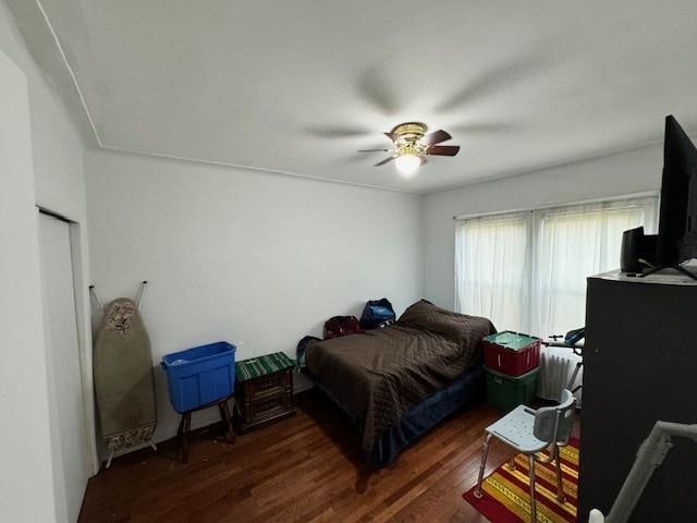 bedroom featuring ceiling fan and dark hardwood / wood-style floors