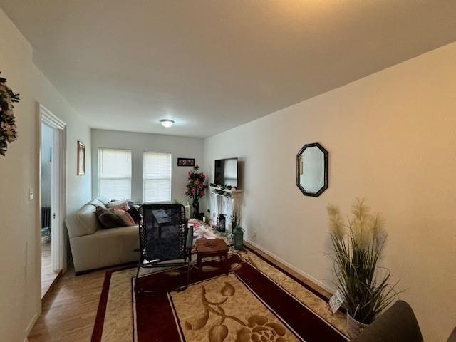 living area with wood finished floors and baseboards