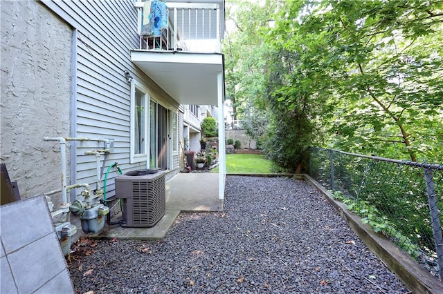 view of yard with central AC unit and a patio area